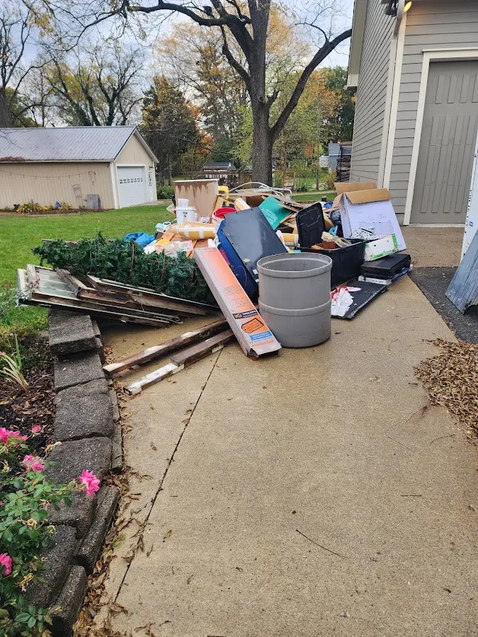 Dumpster being loaded with debris for Demolition Dumpster Rental in Piggott